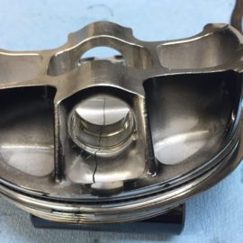 Dirt bike piston failed due to High stress combined with its lightweight design